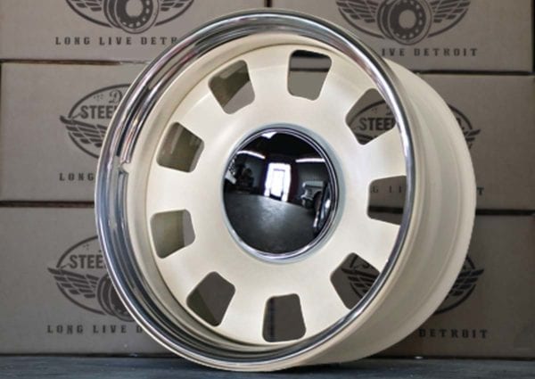A white wheel with chrome rim and six spokes.