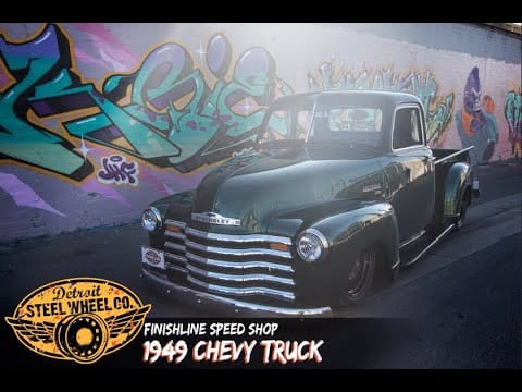 A painting of an old truck with graffiti on it.